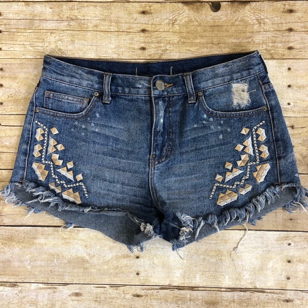 Free People Distressed Embellished Denim Shorts in Medium Blue with Tan Accents